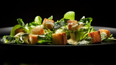 A Homemade Caesar Salad with fresh romaine, crunchy homemade croutons, and a tangy, creamy Parmesan dressing.